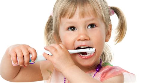 Child brushing teeth with proper technique to maintain oral hygiene and prevent cavities in Surbiton