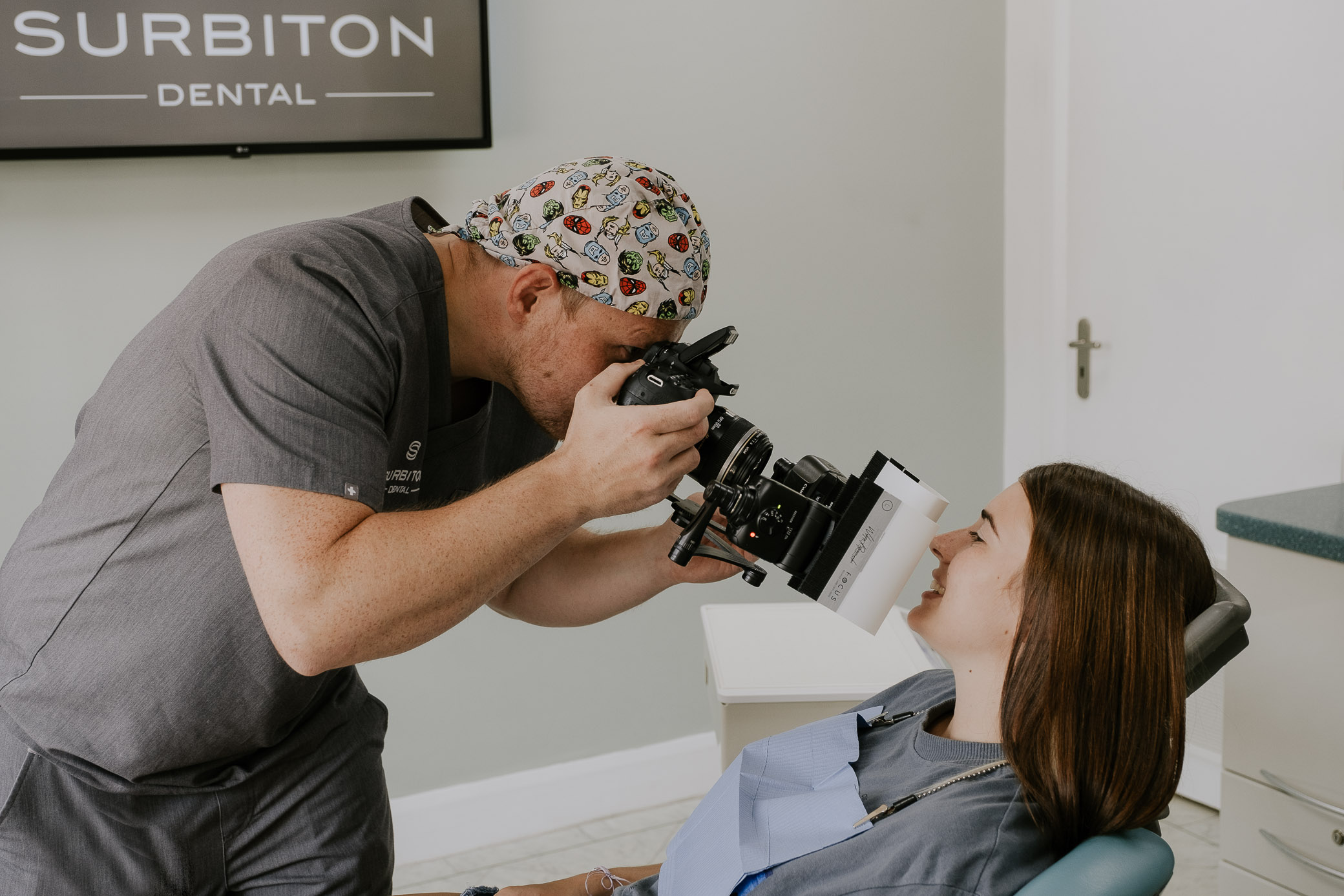 Dentist taking professional clinical photography of a patient's smile for cosmetic planning