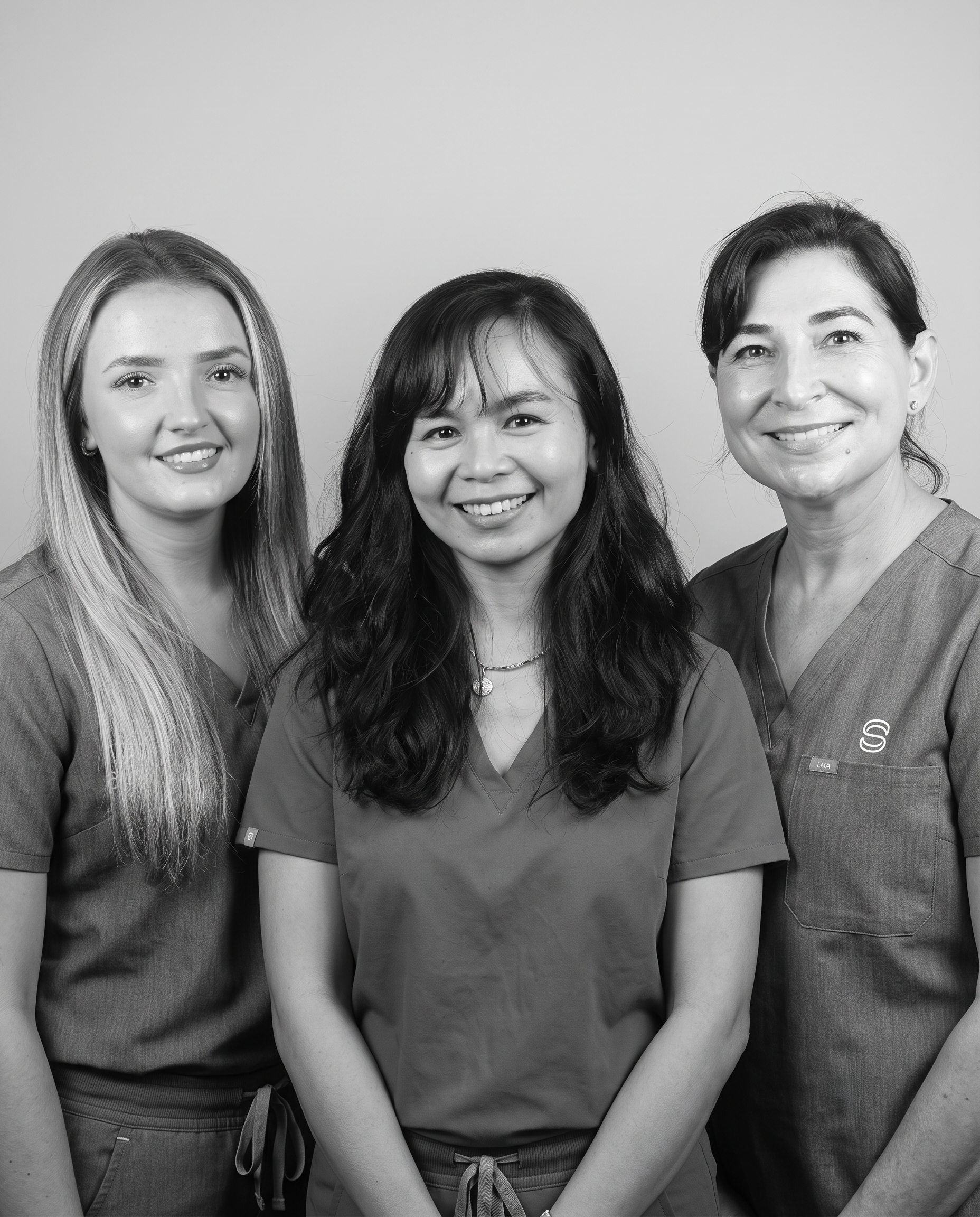 Black and white portrait of Daisy, Esti, and Mia from the hygiene team at Surbiton Dental